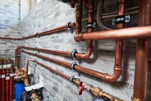 Copper pipeline of a heating system in boiler room https://arcadeestimating.com/all-trades/